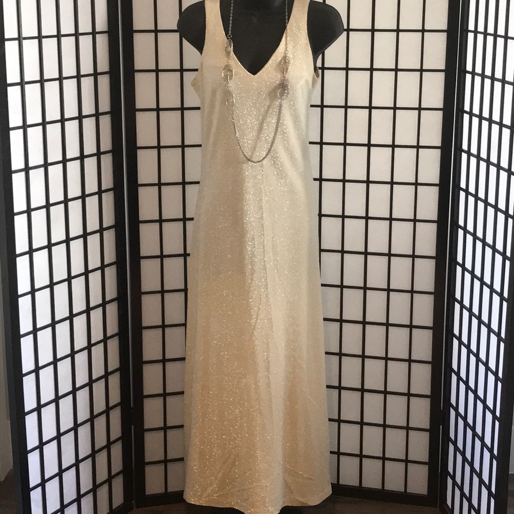 A long sleeveless yellow and silver dress